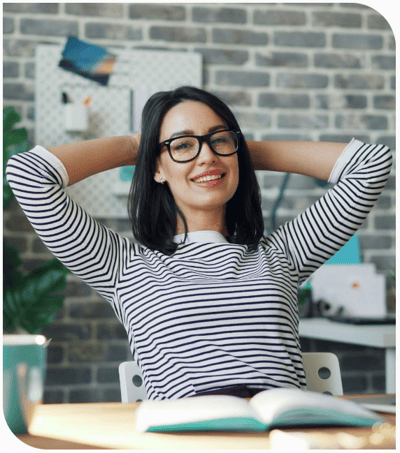 694a4ed8e29d606df2ce4d52_portrait of happy young woman relaxing in offce with cup of coffee_unsplash-crop